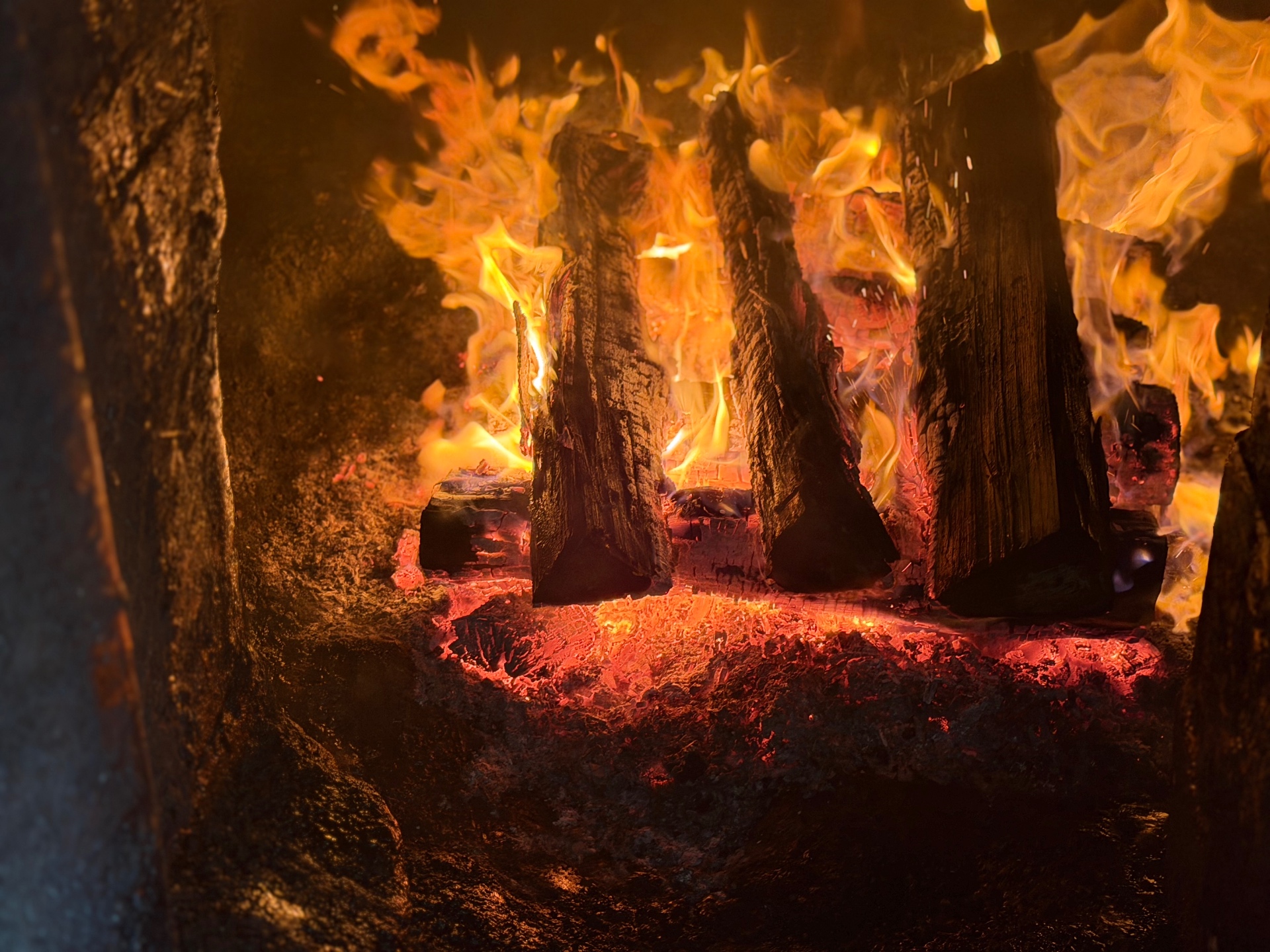 Hickory logs blazing inside the Hilltop pit firebox